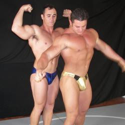 Frank the Tank and Ace Hanson posing a flexing pecs, abs, arms, and thighs
