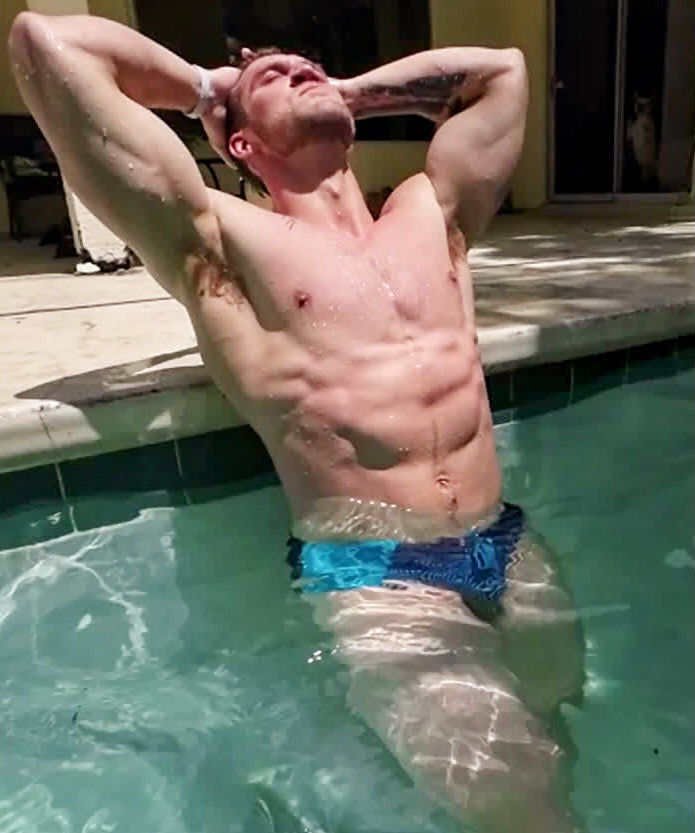 muscle hunk flexing abs in water