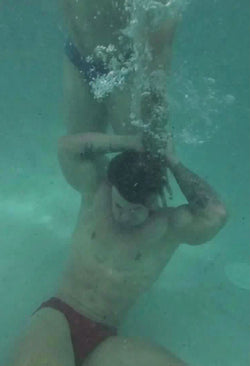 Cason holding Loki underwater 