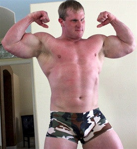 Luger hits a pose, flexing his massive biceps and pecs