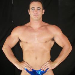 Ace Hanson poses and flexes his chest abs and arms