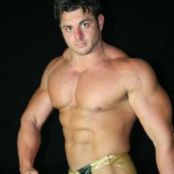 Frank The Tank flexes massive pecs, arms, and shredded abs