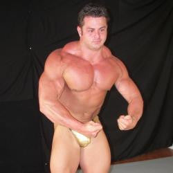 Frank The Tank flexes massive pecs, arms, and shredded abs