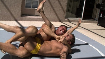 Johnny Bravo ties up Zman on the mat in a brutal submission hold in Thunders Arena