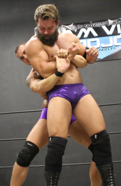 wrestlers bear hug each other