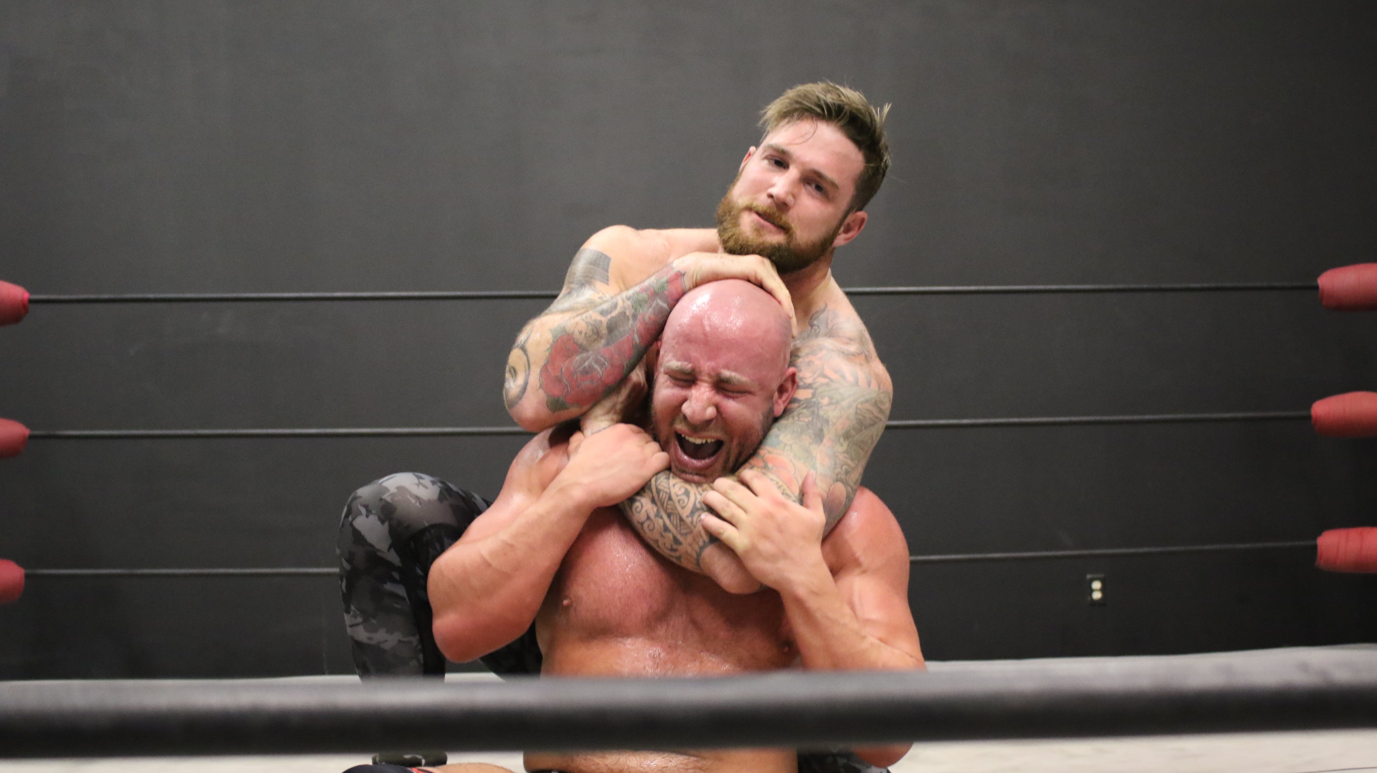 Viking puts Brute into a head lock on thunders arena