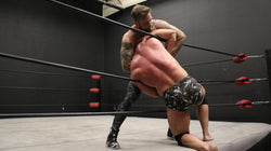 Viking has Brute in a head lock in between the ropes on thunders arena 