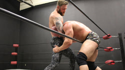 Viking has Brute in a head lock on thunders arena 