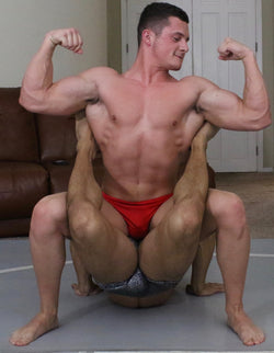 Cap flexes while putting Achilles into a boston crab at Thunders Arena Wrestling. 