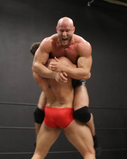 Cason puts Brute in a bear hug at Thunders Arena Wrestling 