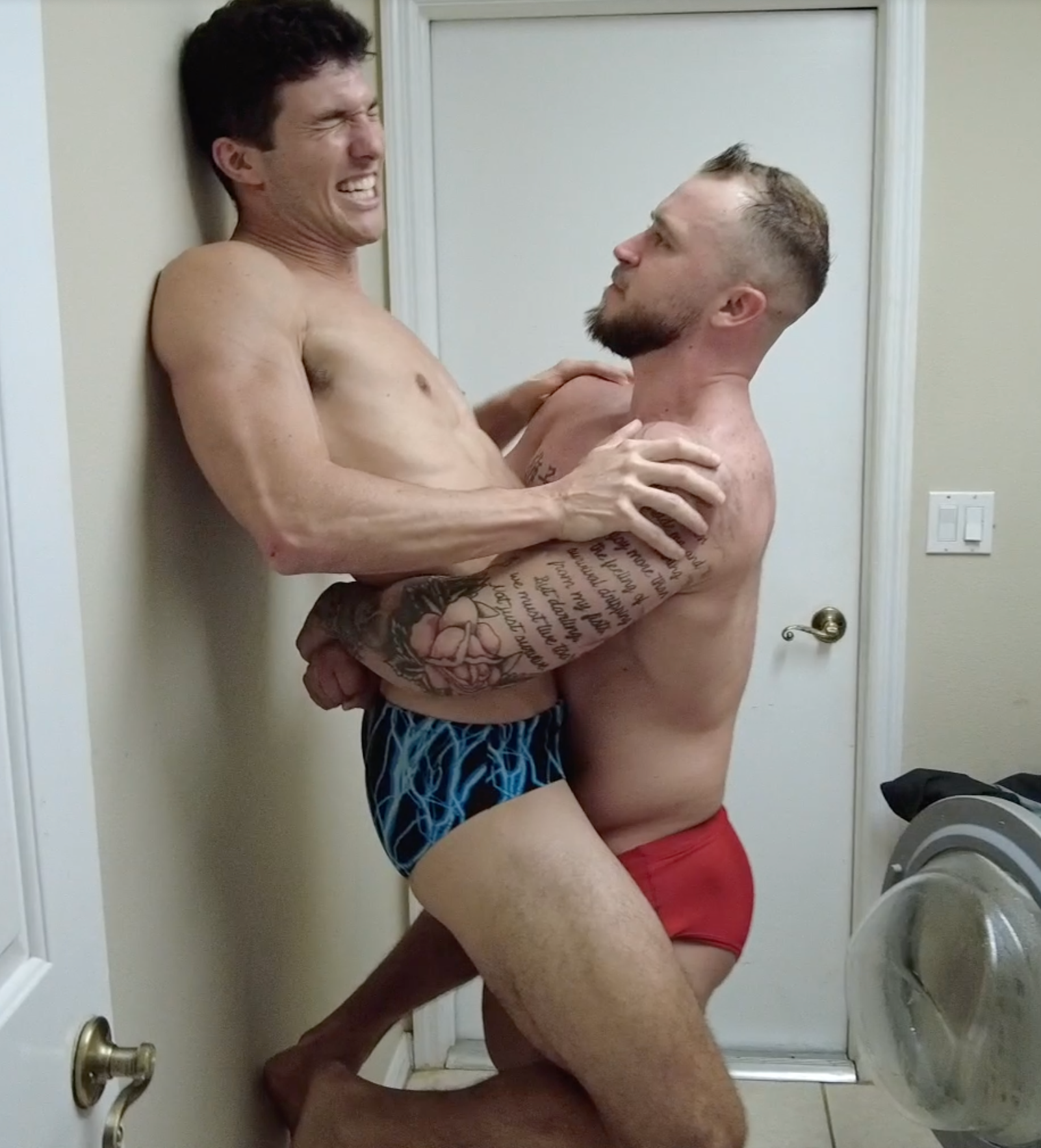 Dom9 bear hugging Ashton89 against the laundry room wall