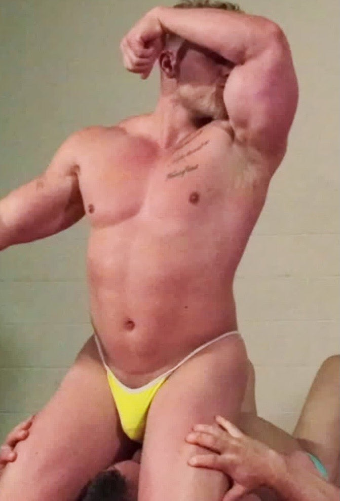 Bodybuilder kisses bicep