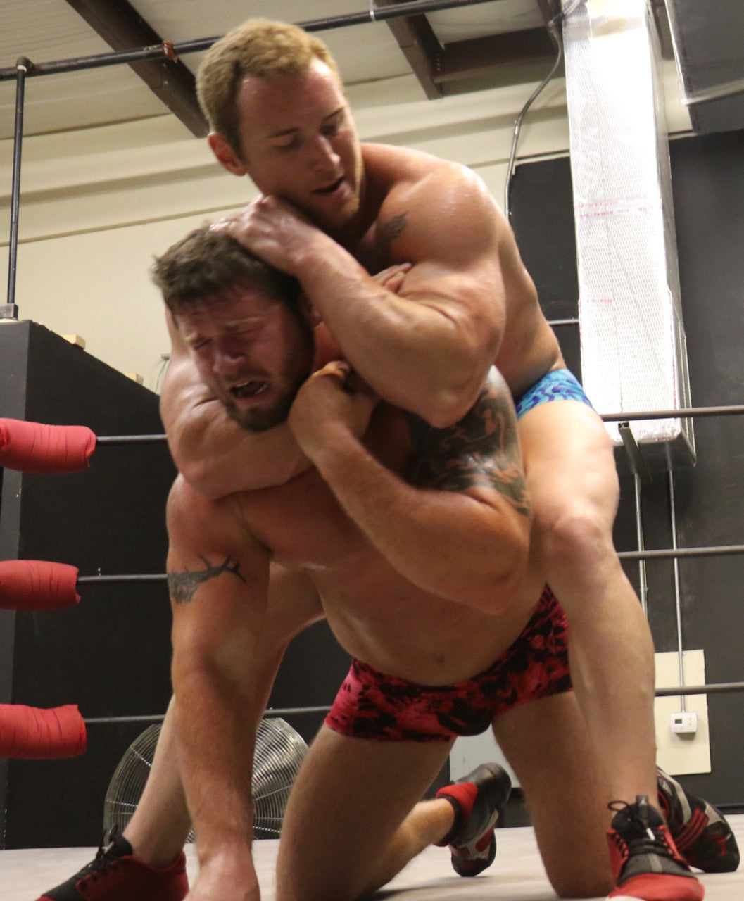 Talon puts Beast in a headlock from above