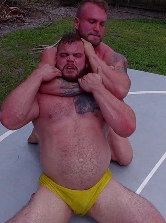 Gunner puts Wildcard into a sleeper hold at Thunders Arena Wrestling. 