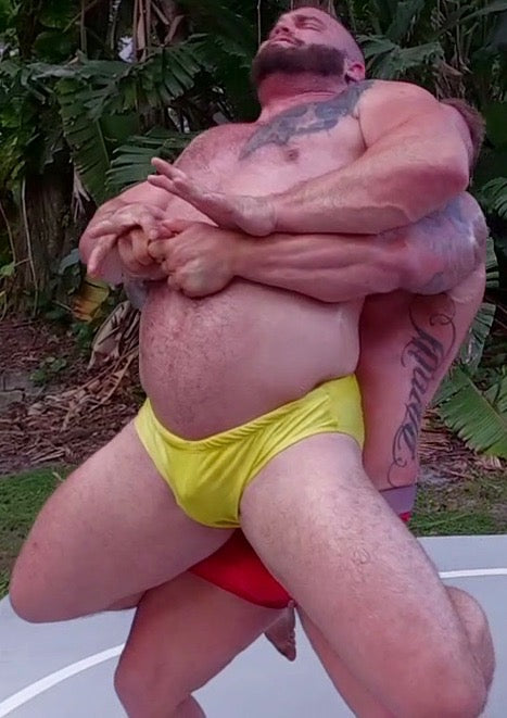 Gunner puts Wildcard into a bearhug at Thunders Arena Wrestling