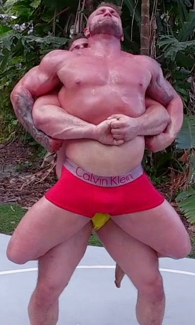 Wildcard puts Gunner into a bearhug at Thunders Arena Wrestling. 