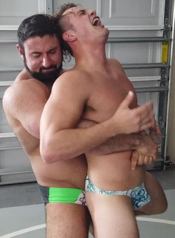 Gino puts Van Acker into a bear hug at Thunders Arena Wrestling. 