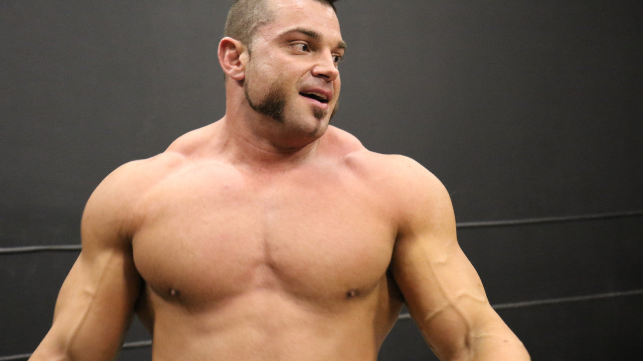 Brian Cage power pose pecs traps arms