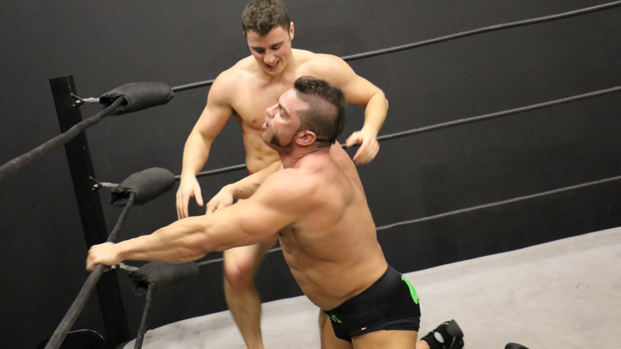 Bolt throws Brian Cage into the ropes arms tricep