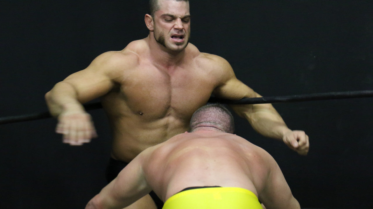 Brian Cage pinned in the corner on the ropes by Joey King big pecs