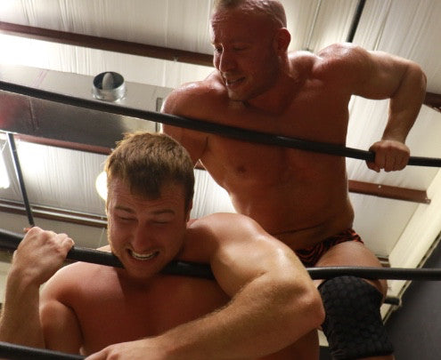 Brute chokes Frey on the ropes arms biceps 