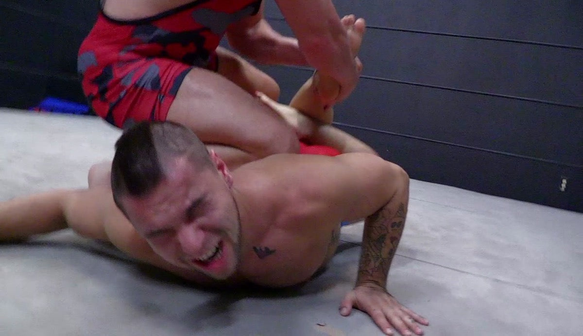 Brute puts Aspen into a Boston Crab at Thunders Arena Wrestling. 