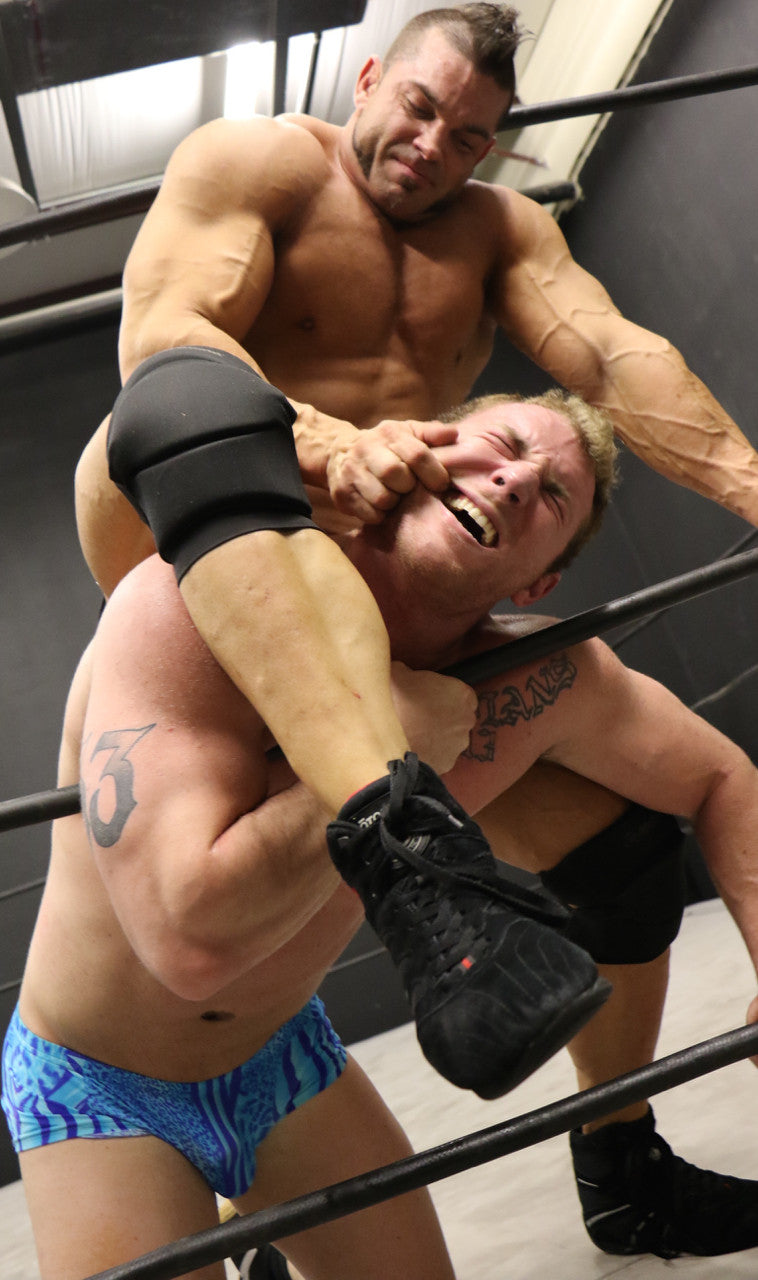 Brian Cage chokes Talon on the ropes big arms bicep