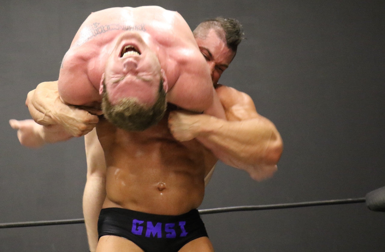 Brian Cage lifts Talon into a backbreaker submission forearm
