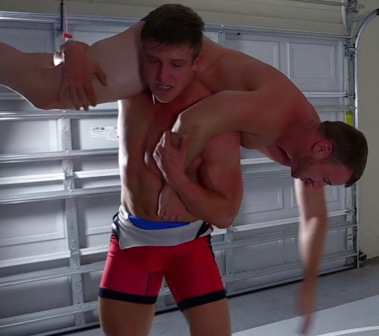 body builder in an over the shoulder fireman's carry