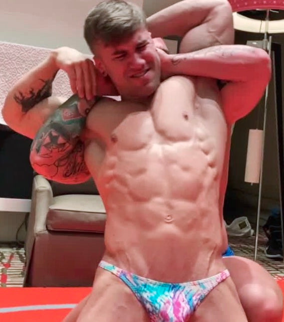 KaSee puts Loki into a full Nelson at Thunders Arena Wrestling . 