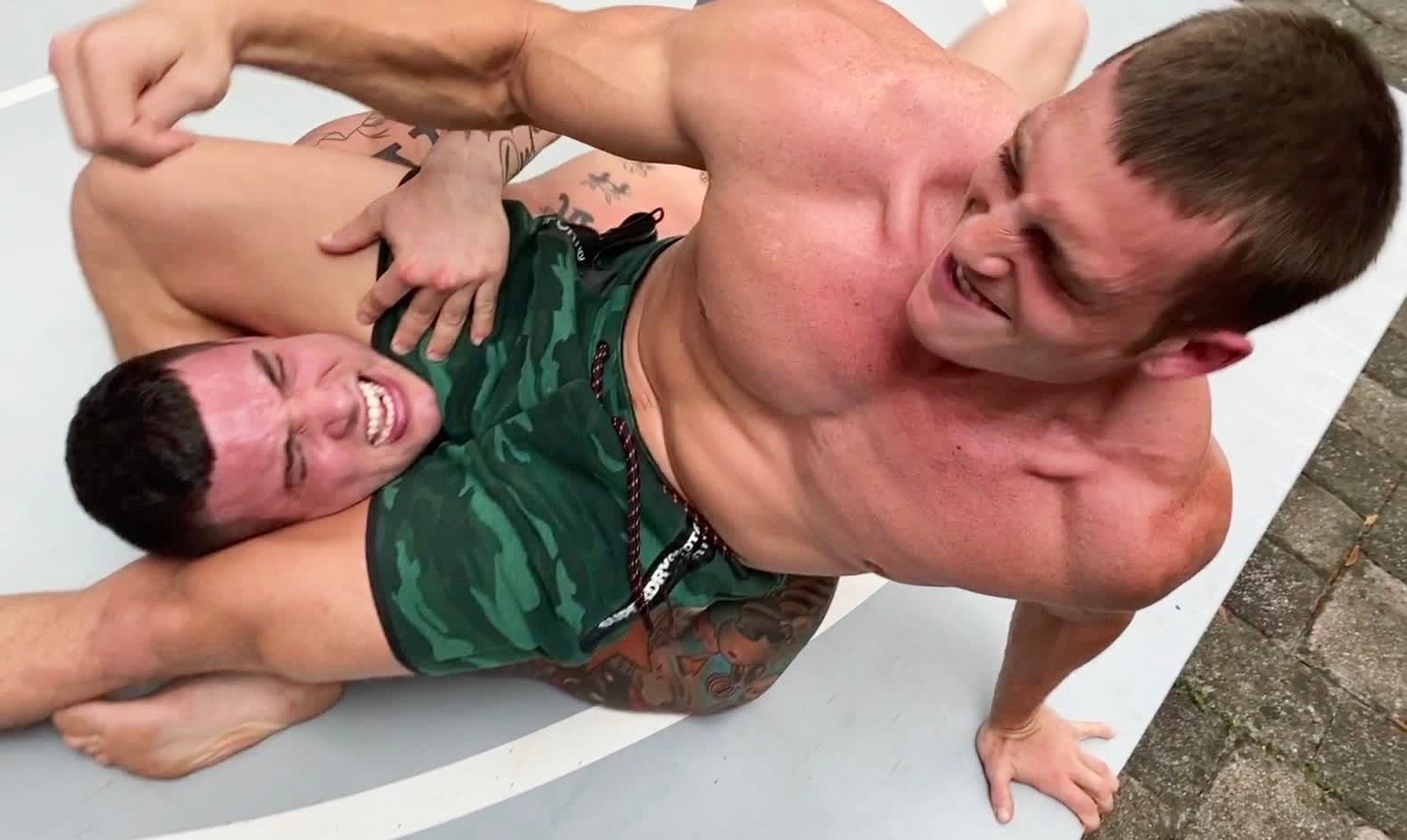 Scrappy puts Hero into a head scissor at Thunders Arena Wrestling. 