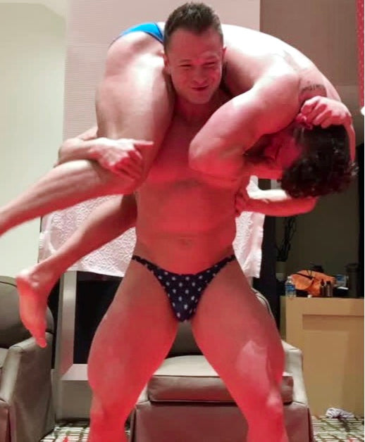 Steel puts Mercury into a fireman's carry at Thunders Arena Wrestling. 