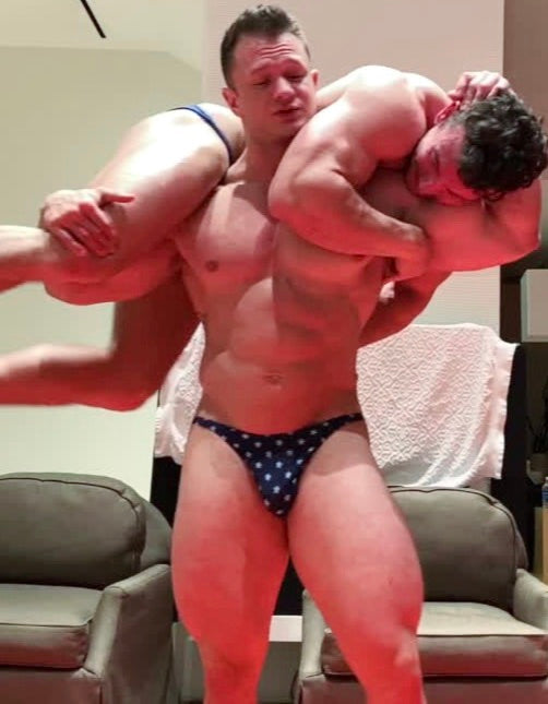 Steel puts Mercury into a fireman's carry at Thunders Arena Wrestling. 