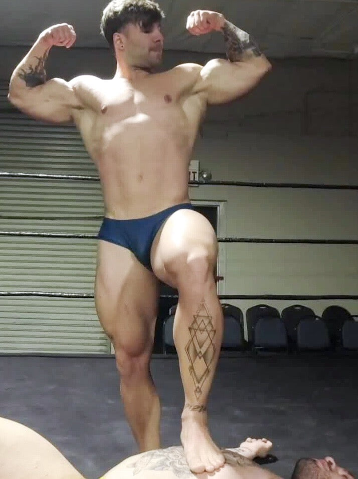 Loki flexing with foot on opponent