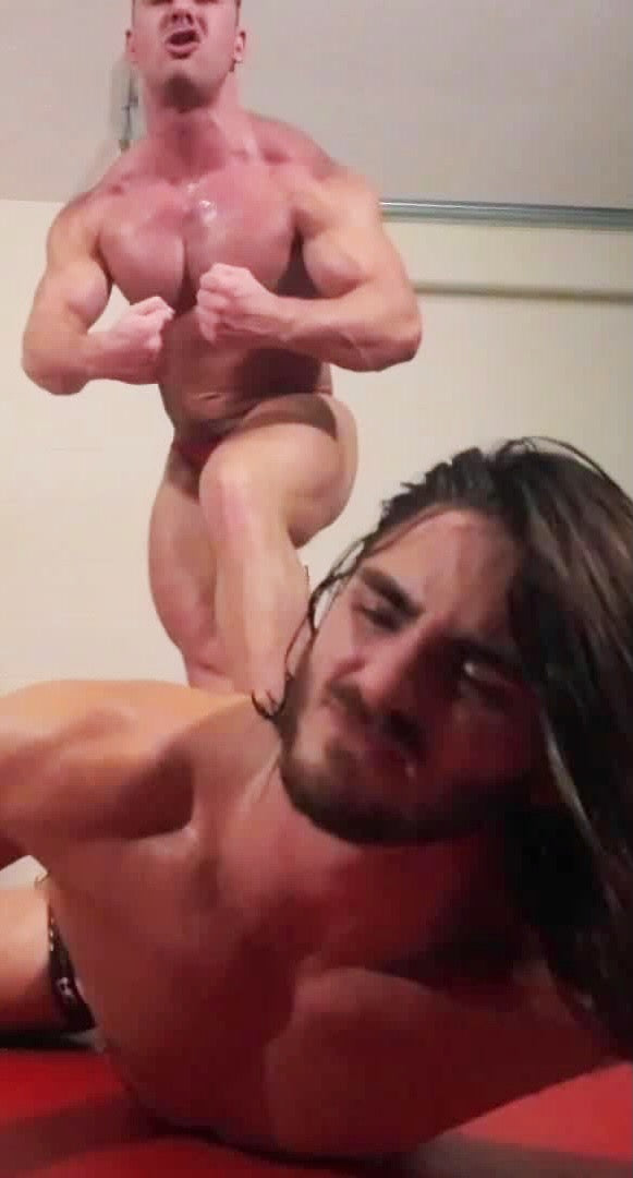 Bodybuilder stomping and flexing on opponent