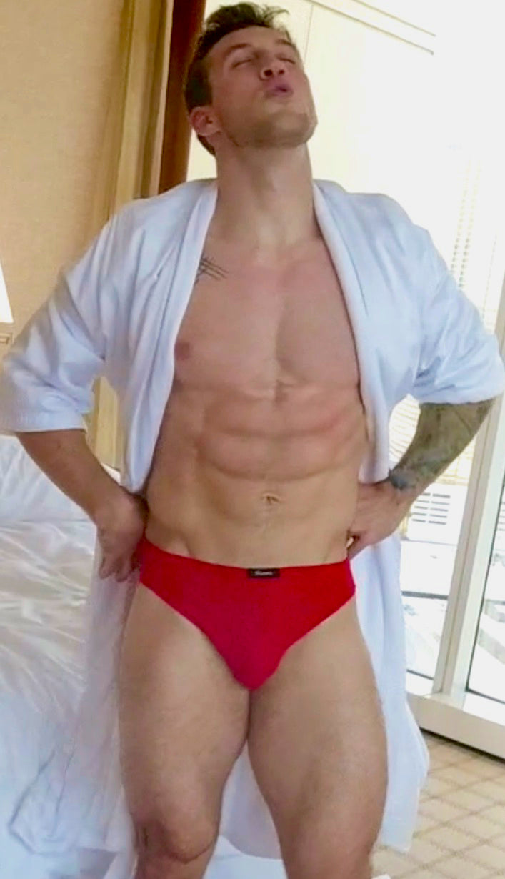 Cason flexing while wearing a robe