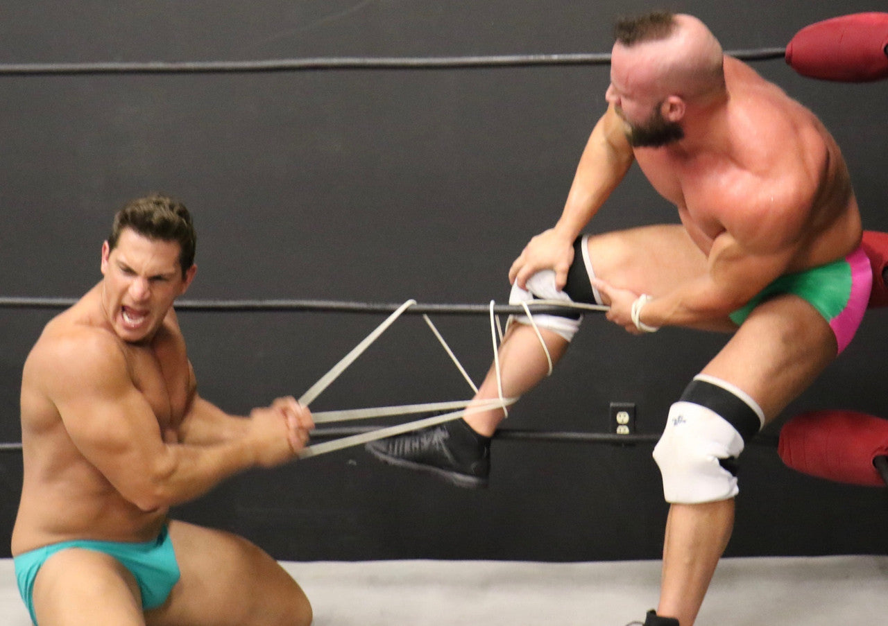 PeeWee uses his ropes against Brute bicep tricep