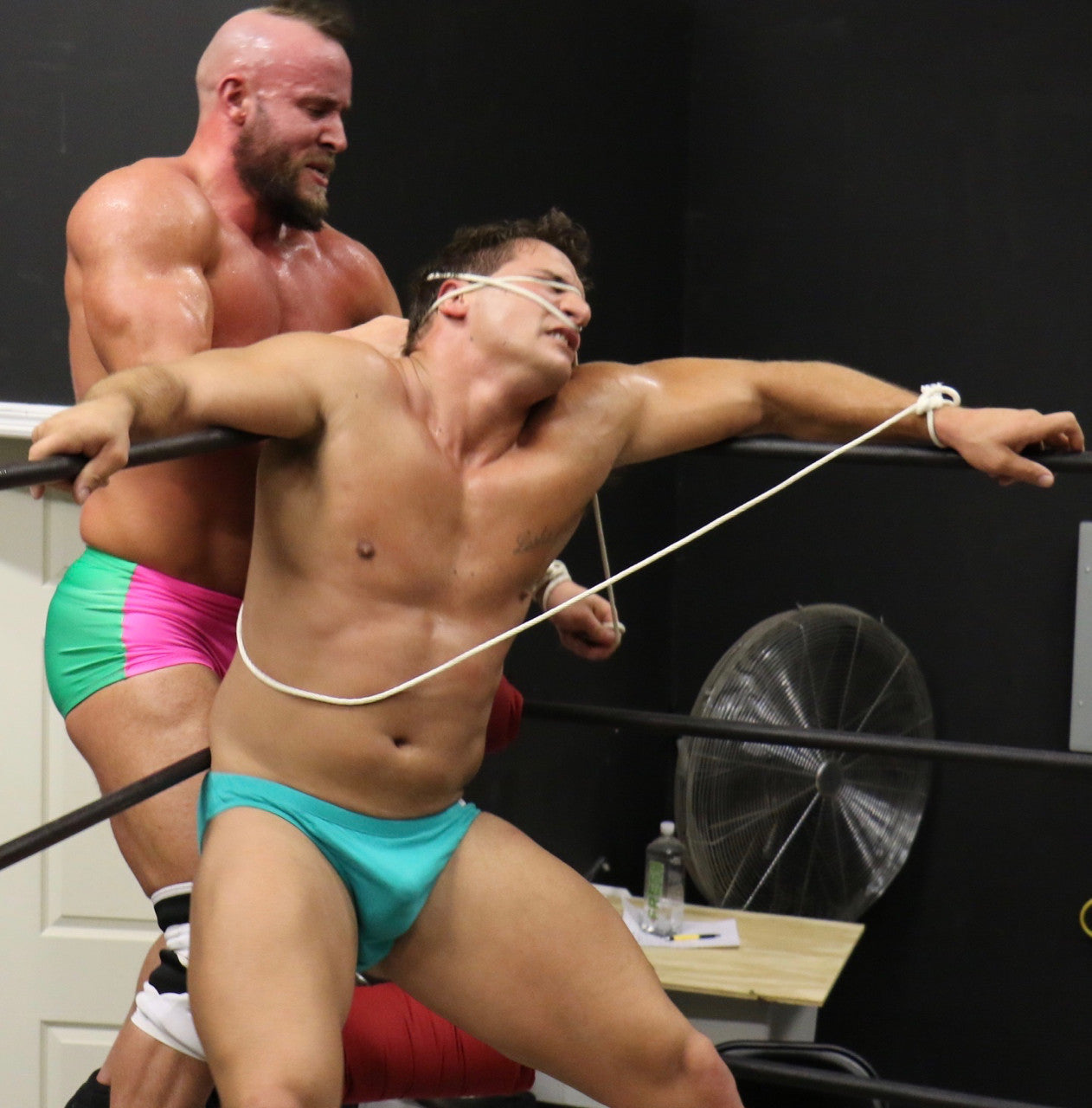 Brute ties up PeeWee in the corner of the wonder of the ring on the ropes