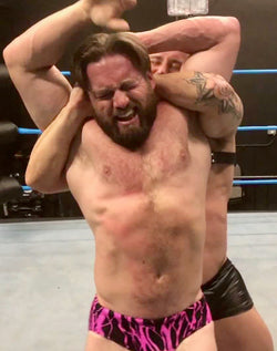 Dom Knight puts Joey King into a full nelson at Thunders Arena Wrestling.