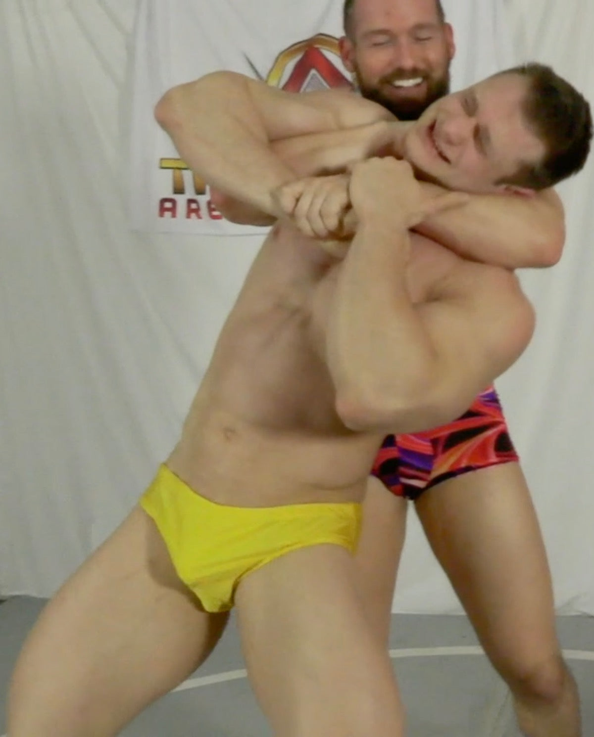 body builders in a head lock