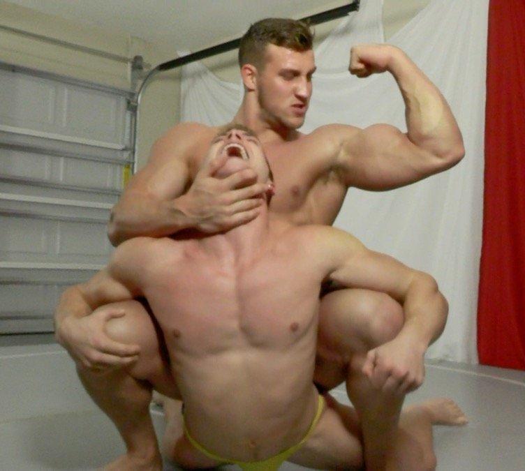 Cason puts Scrappy into a chin lock while flexing his strong muscles on Thunders Arena Wrestling. 