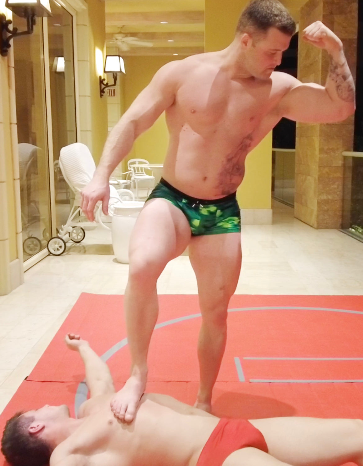 Jarhead bicep flexing while standing on Cap