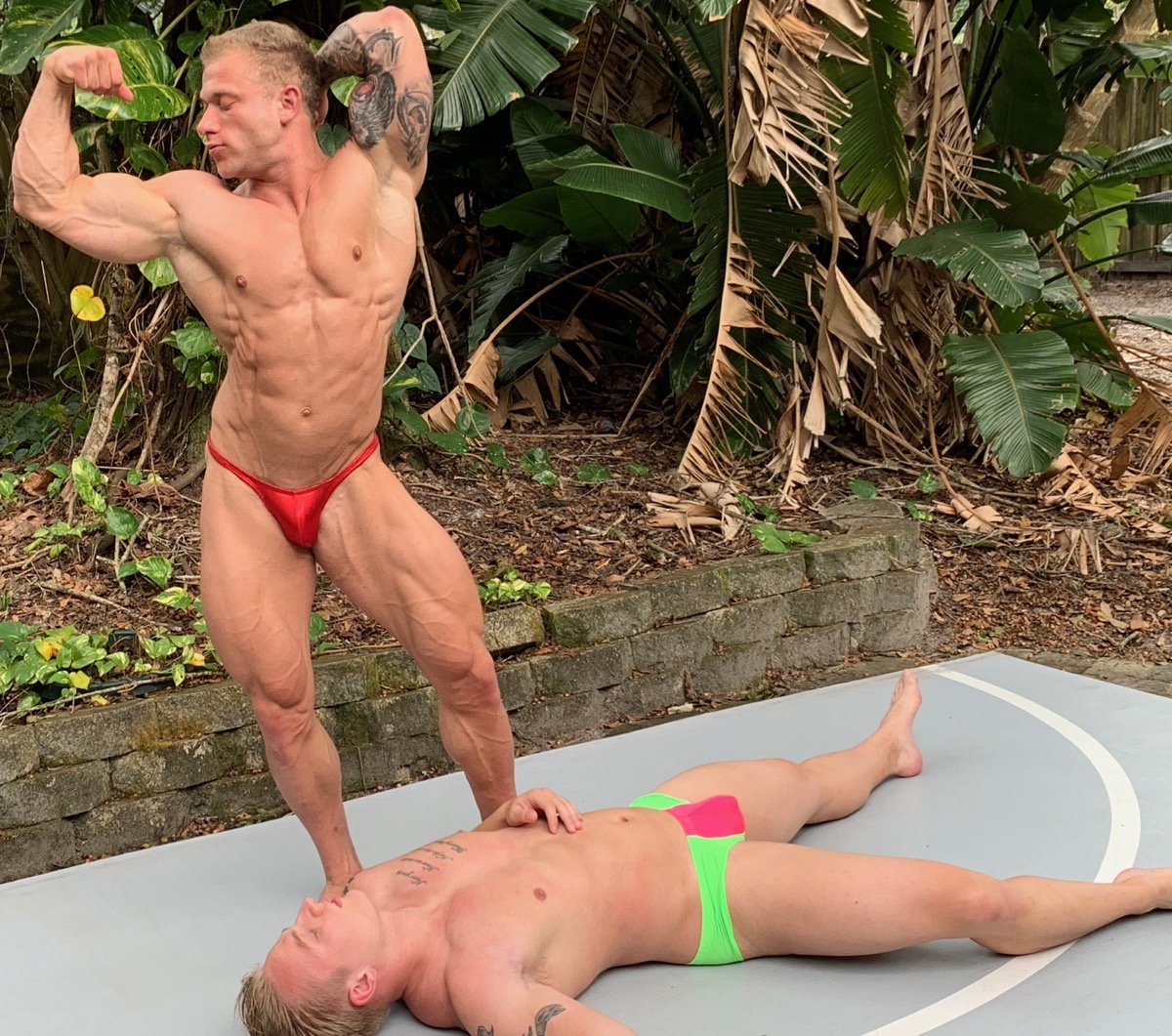 Jake flexes over Iceman18 at Thunders Arena Wrestling.