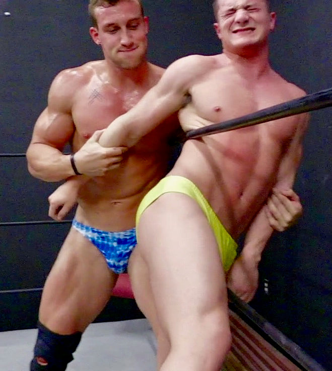 muscular men holding each other on the ropes