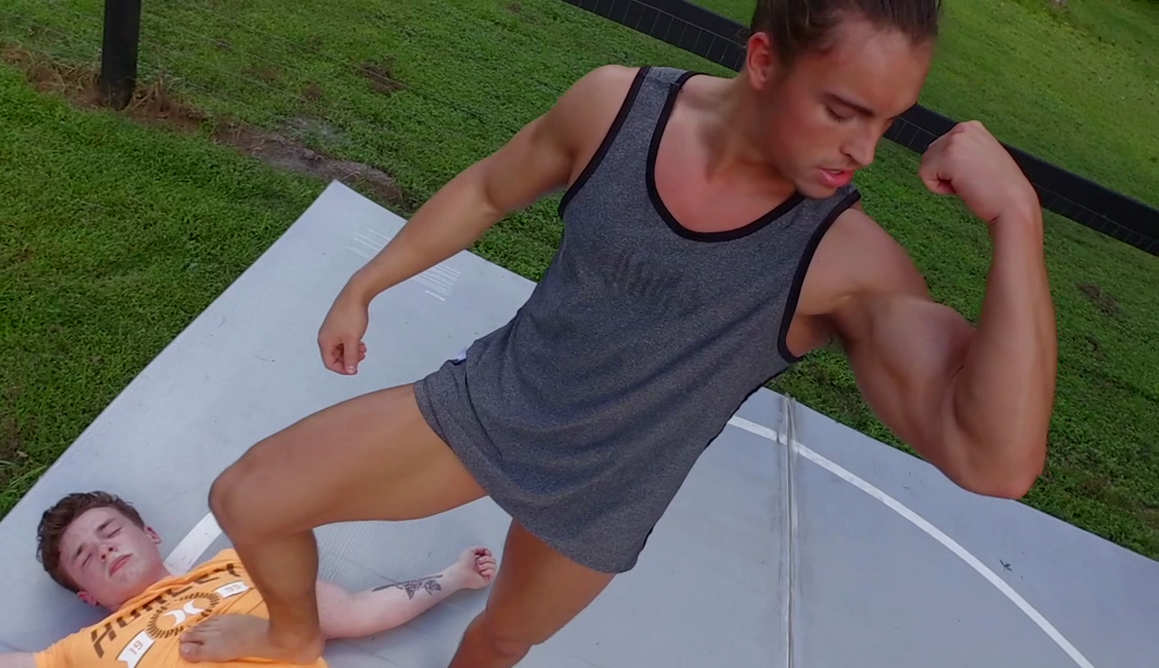 Jack Beaver flexes over Kid Thing at Thunders Arena Wrestling. 