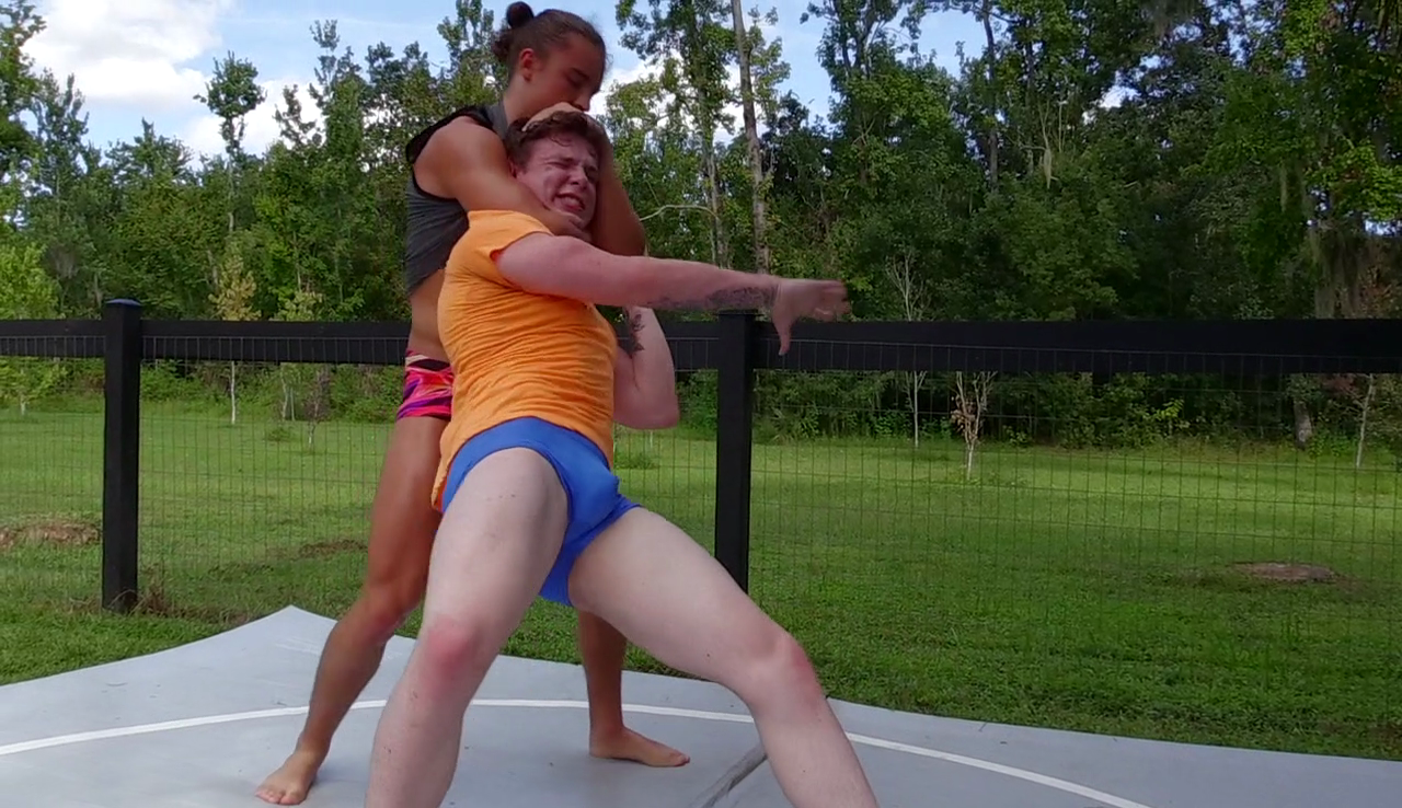Jack Beaver grabs Kid Thing from behind at Thunders Arena Wrestling. 